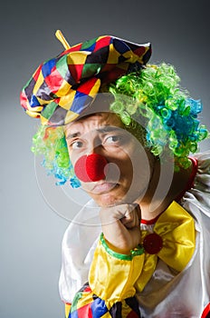 The funny clown in comical concept