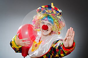 The funny clown in comical concept