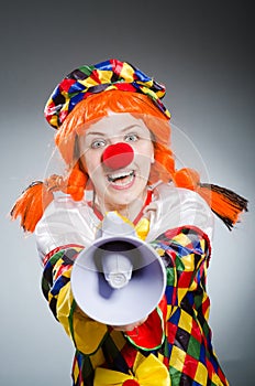 The funny clown in comical concept