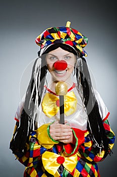 The funny clown in comical concept