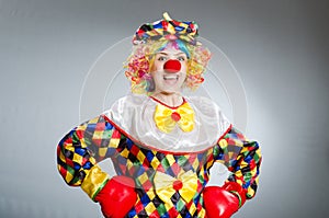 The funny clown in comical concept