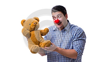 Funny clown man with a soft teddy bear toy isolated on white bac