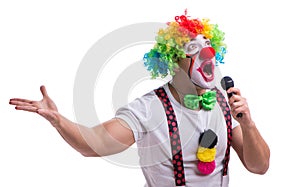 Funny clown with a microphone singing karaoke isolated on white