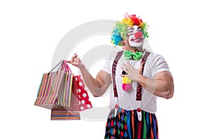 Funny clown after shopping bags isolated on white background