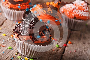 Funny colorful Halloween cupcakes decorated with chocolate hat