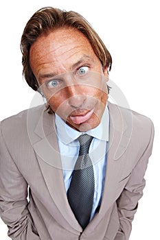 Funny, comic and portrait of a business man with a silly face and a suit with white background. Crazy, joke and comedy