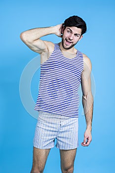 Funny Concepts. Caucasian Handsome Brunet Man in Striped Underware During Early Morning Yawing While Scratching His Heand From