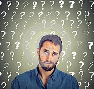 Funny confused skeptical man thinking looking up has many questions