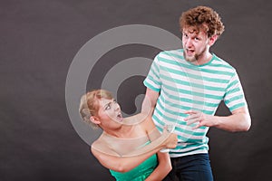 Funny couple fighting over the TV remote
