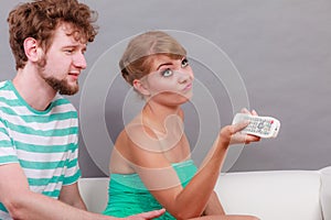 Funny couple fighting over the TV remote