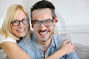 Funny couple at home with eyeglasses