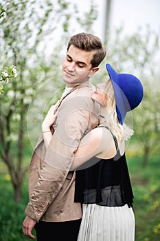 Funny couple laughing with a white perfect smile and looking each other outdoors