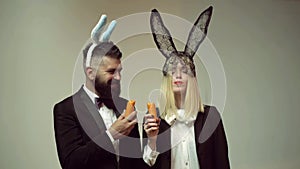 Funny couple rabbit eat carrot. Bunny ears concept with bunny couple. Heppy easter couple.