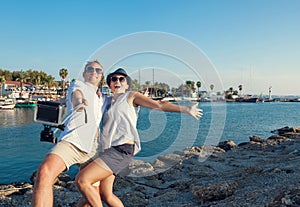 Funny couple take a selfie in the sea bay