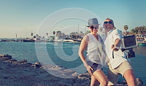 Funny couple take vacation selfie on the sea bay