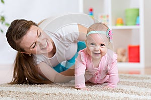 Funny crawling baby girl with mother