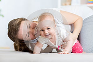 Funny crawling baby girl with mother at home