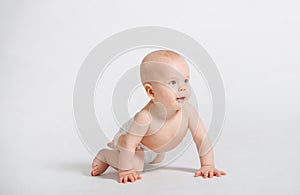 Funny crawling baby isolated on white background. Closeup
