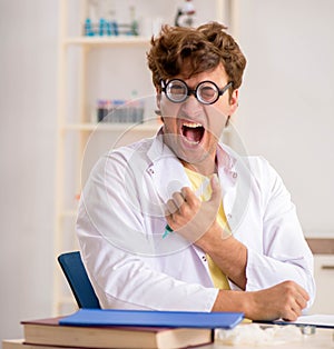 Funny crazy chemist doing experiments and tests