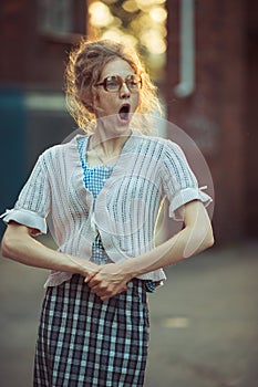 Funny crazy girl student in glasses and a vintage dress