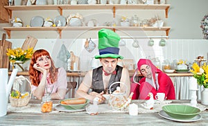 Funny crazy group of friends fool around with mad tea party concept