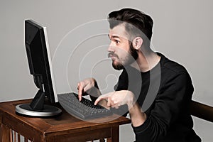 Funny and crazy man using a computer