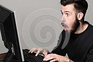 Funny and crazy man using a computer