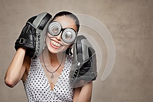 Funny crazy woman with big eyes, glasses and boxing gloves