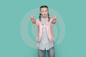 Funny crosseyed teenager girl holding two eyewear, having very bad eyesight, choosing eyeglasses.