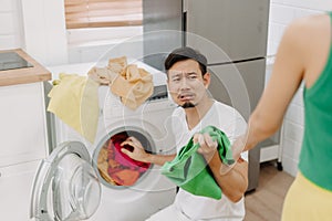 Funny crying face reaction of husband being forced to wash clothes by wife.