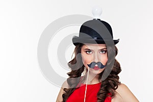 Funny curly woman in ridiculous black hat with light bulb