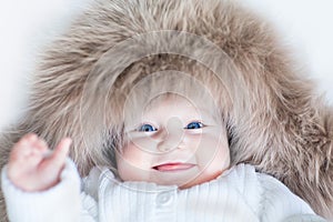 Funny cute baby girl wearing huge winter hat