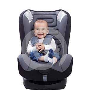 Funny cute baby sitting in a car seat, isolated