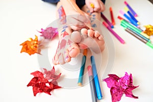 Funny cute bare feet. Child painting coloring feet