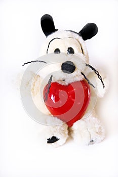 Funny cute dog  toy  with a heart.  Preparation for a romantic holiday. Valentines Day, Birthday  and love Concept. White