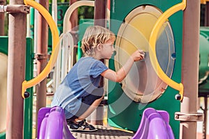 Funny cute happy baby playing on the playground. The emotion of happiness, fun, joy