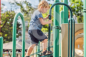 Funny cute happy baby playing on the playground. The emotion of happiness, fun, joy