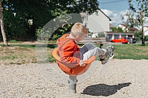 Funny cute happy baby playing on the playground. The emotion of happiness, fun, joy. Smile of a child. boy playing on