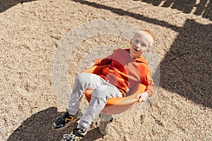 Funny cute happy baby playing on the playground. The emotion of happiness, fun, joy. Smile of a child. boy playing on