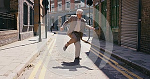 Funny, dance and senior man in city, street or having happy fun. Energy, freedom and carefree, excited and comic elderly