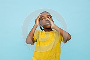 Funny dark- skinned little boy screaming something with hand near mouth