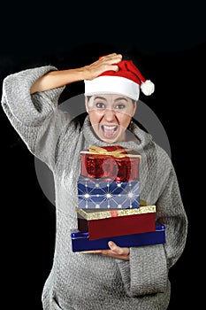 Funny desperate woman in Santa Christmas hat in stress about December gifts and presents shopping screaming