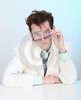 Funny disheveled young man in glasses