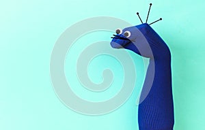 Funny doll sock on blue background, hand theater - Image