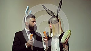 Funny easter bunny. Happy funny easter couple with carrot. Family celebrate Easter. Easter rabbits. Couple with bunny