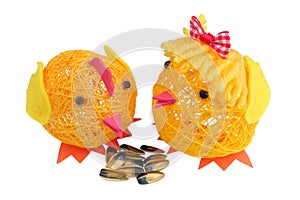 Funny Easter chicks are made of thread and peck sunflower seeds isolated photo