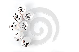 Funny easter eggs with different funny faces on white.