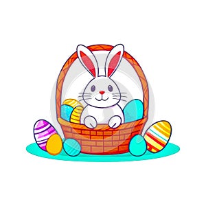 Funny Easter Rabbit in the Basket Isolated on white. Wicker basket of colorful eggs and cute white bunny