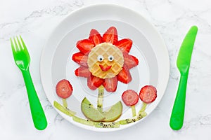 Funny edible flower from strawberry kiwi and waffle