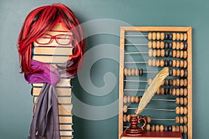 Funny education concept with beautiful teacher with luxurious red hair teaching arithmetic with the help of abacus